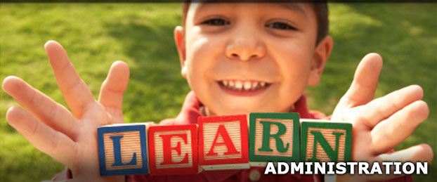 A child holding up building blocks that spell out LEARN, used to represent the Administration Department